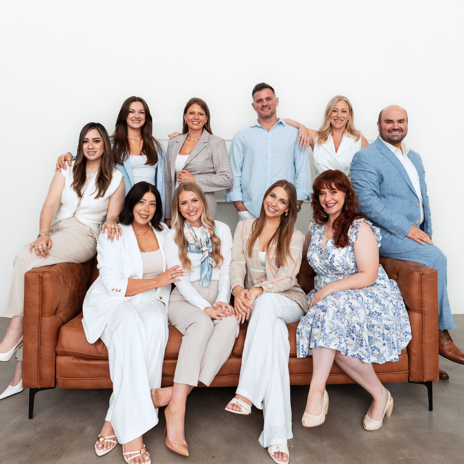 The Schroeder & Co. team together on a leather sofa